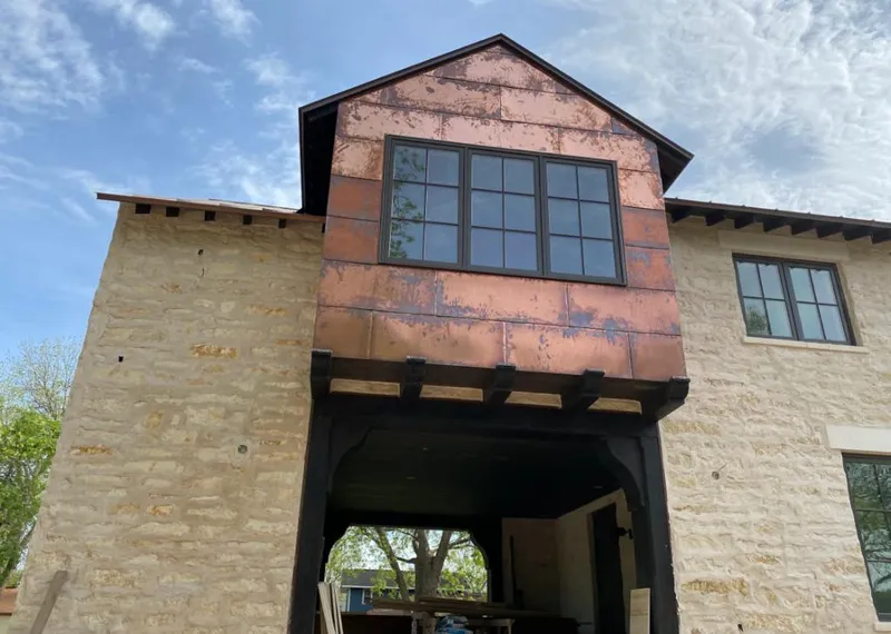 Copper metal panel facade on a stone building for Skylight Installation in Lemoore Station